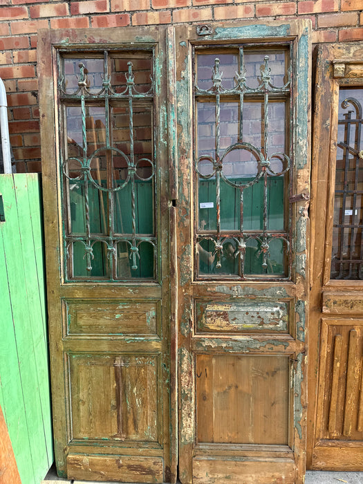 PAIR OF EGYPTIAN IRON INSET GREEN WOOD DOORS WITH CASEMENT WINDOWS