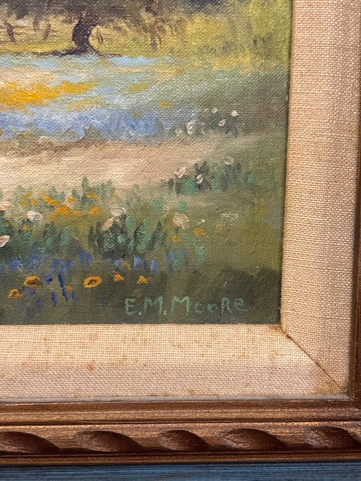 BROWN AND BLUE FRAMED OIL PAINTING OF BARN AND BLUE BONNETS WITH LINEN FILET - SIGNED E. M. MOORE