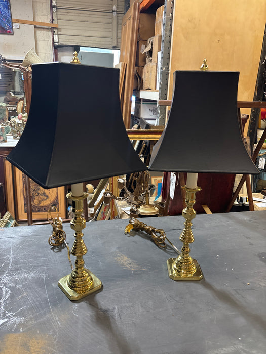 PAIR OF BRASS CANDLESTICK LAMPS WITH BLACK SHAPED SHADES