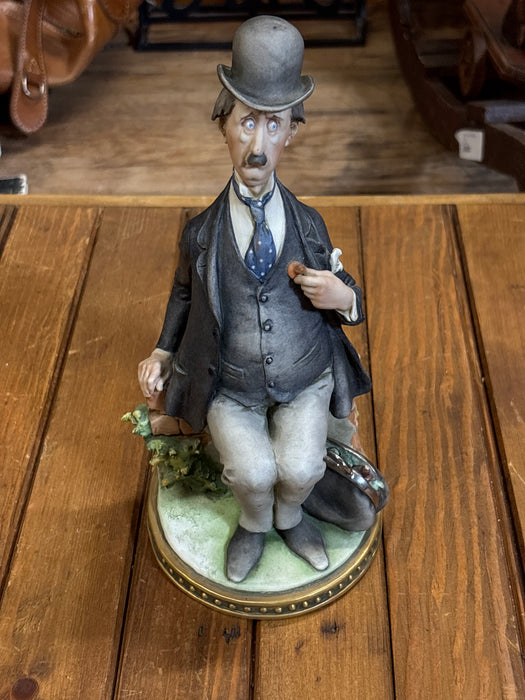 ITALIAN STATUE OF MAN SITTING ON BRICK WALL IN SUIT