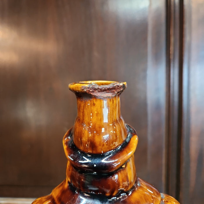 MAN ON BARREL POTTERY BOTTLE