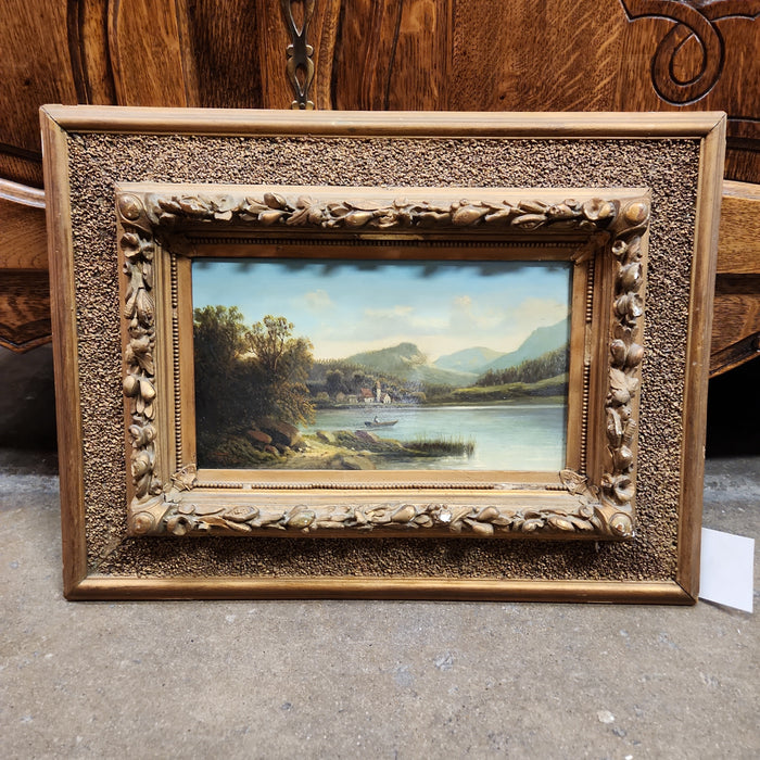 HORIZONTAL OIL PAINTING ON BOARD WITH MOUNTAIN & LAKE IN GILT FRAME BY REIDER
