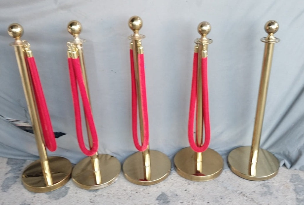 FIVE VINTAGE BRASS RED CARPET STANCHEONS