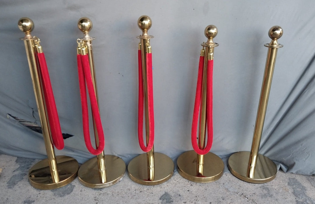 FIVE VINTAGE BRASS RED CARPET STANCHEONS