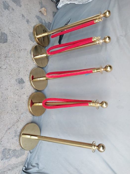 FIVE VINTAGE BRASS RED CARPET STANCHEONS