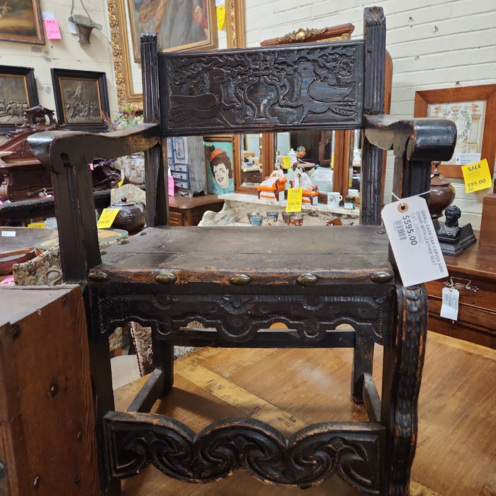 SMALL DARK OAK CARVED ARM CHAIR WITH LEATHER SEAT