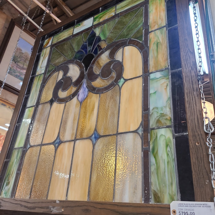 LARGE SLAG GLASS WINDOW WITH CURLES AND COLORED FAN- AS FOUND