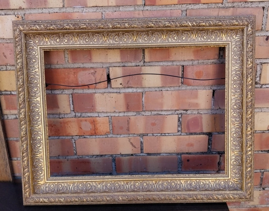 SMALL ORNATE GILT FRAME WITH LEAF TRIM