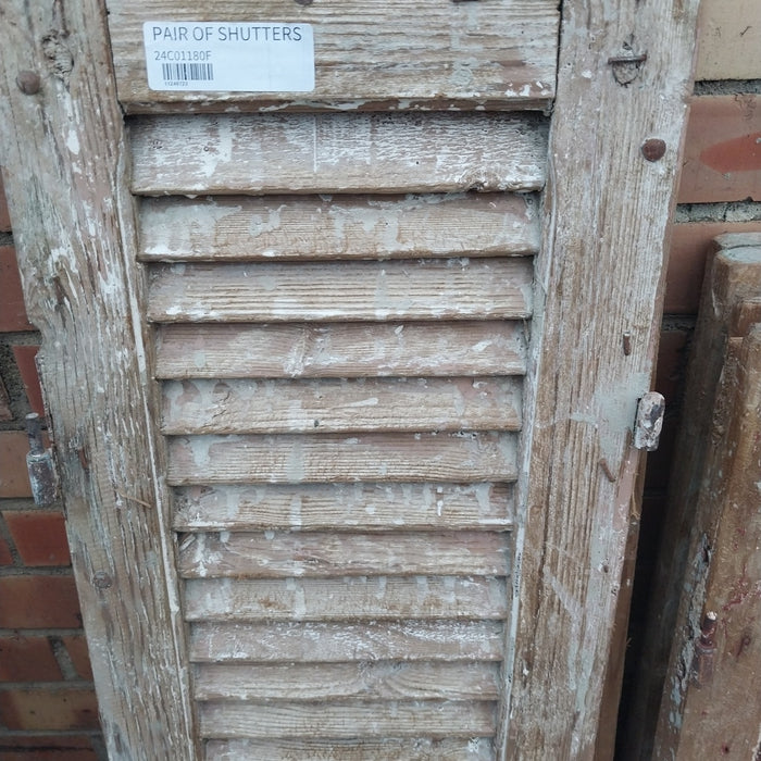 PAIR OF DISTRESSED SHUTTERS WITH BROWN PAINT