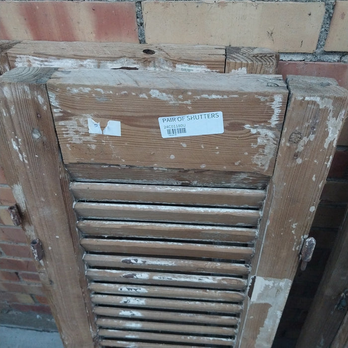 PAIR OF DISTRESSED SHUTTERS WITH BROWN PAINT