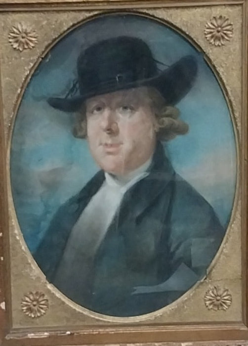 ORNATELY FRAMED WATERCOLOR OF A MAN WEARING A HAT
