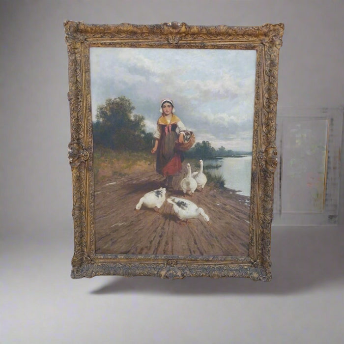 FRAMED ANTIQUE OIL PAINTING OF A GIRL WALKING WITH GEESE