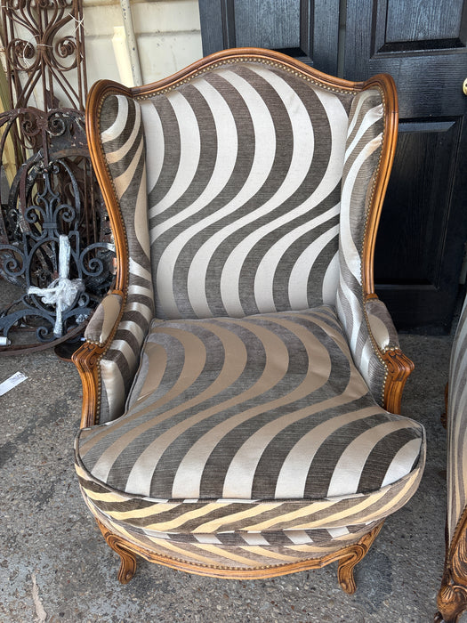 MISMATCHED PAIR OF SWIRLY ZEBRA UPHOLSTERED WING BACK CHAIRS
