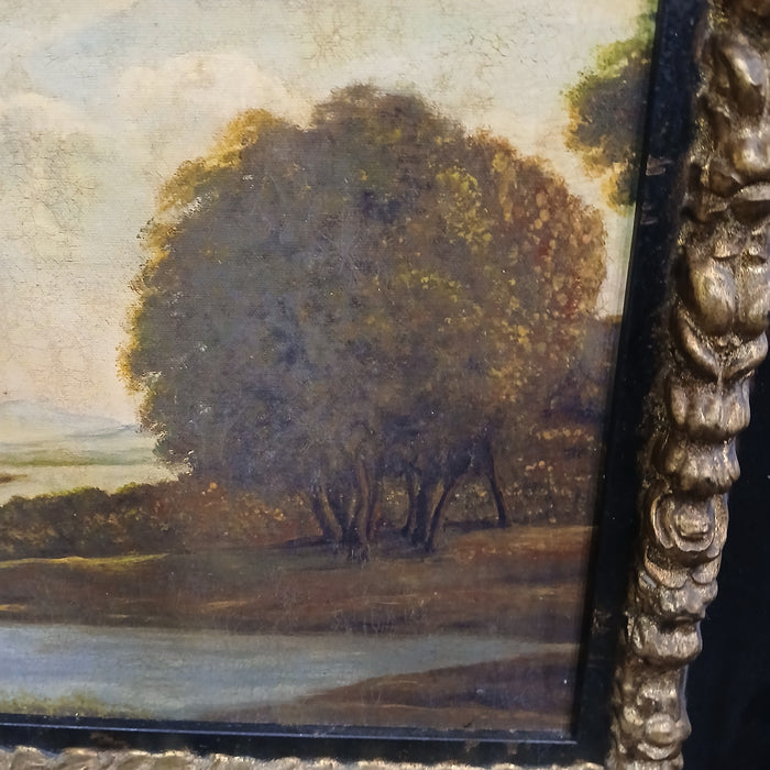 BLACK FRAMED OIL PAINTING OF TREES AND RIVER