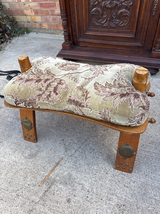 FOLDING WOOD CAMEL SADDLE STOOL WITH GREEN AND PURPLE FLORAL CUSHION