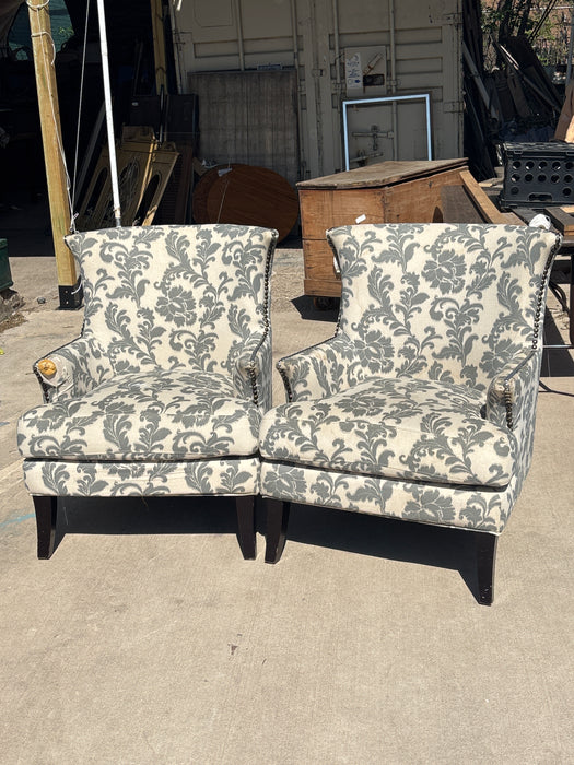 PAIR OF UPHOLSTERED GRAY AND WHITE FOLIATE CHAIRS - AS FOUND
