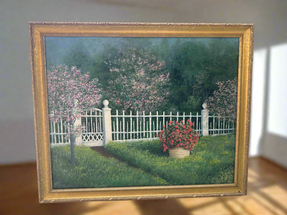 GILT FRAMED OIL PAINTING OF A YARD WITH WHITE PICKETT FENCE AND FLOWERS FLOWERS SIGNED RAYMOND TRINKLEY