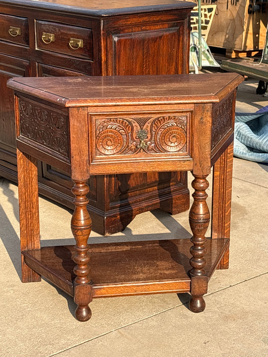 CANTED OAK LUNETTE AND VOLUTE CARVED CONSOLE