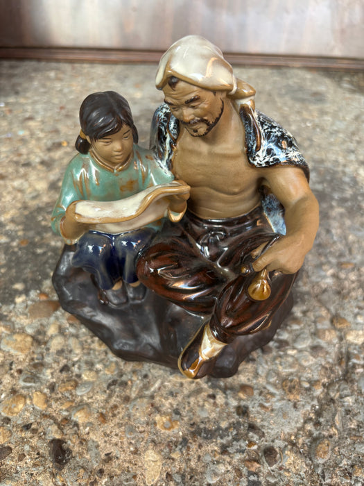 SMALL PORECELAIN MUDMAN STATUE OF GIRL READING TO FATHER ON ROCK