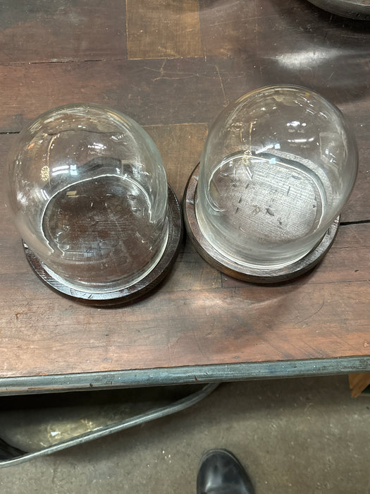 PAIR OF SMALL DOMES WITH BROWN WOOD BASE