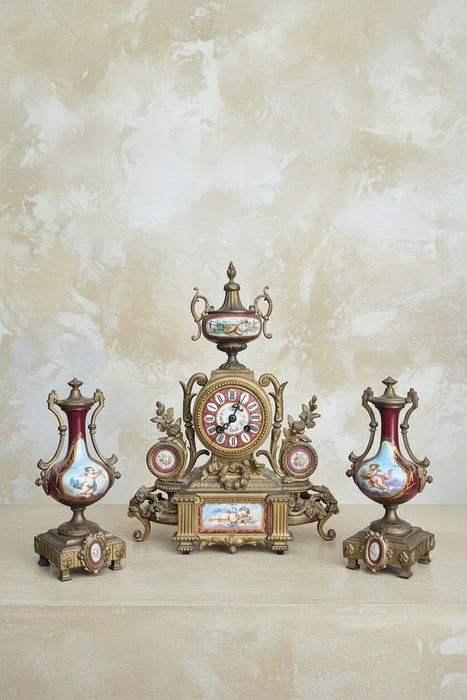 3 PIECE BRASS AND RED PORCELAIN GARNITURE CLOCK SET WITH CHERUBS