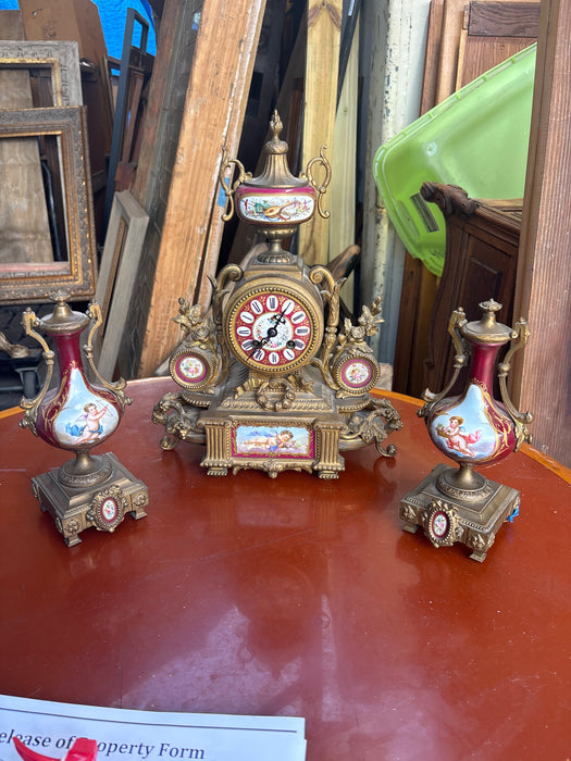 3 PIECE BRASS AND RED PORCELAIN GARNITURE CLOCK SET WITH CHERUBS