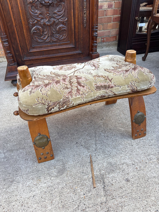 FOLDING WOOD CAMEL SADDLE STOOL WITH GREEN AND PURPLE FLORAL CUSHION