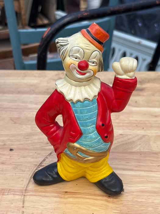 SMALL BLUE AND GREEN POTTERY CLOWN WITH YELLOW BOW