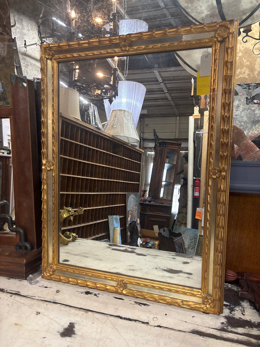 GOLD MIRROR WITH FLORAL ACCENTS