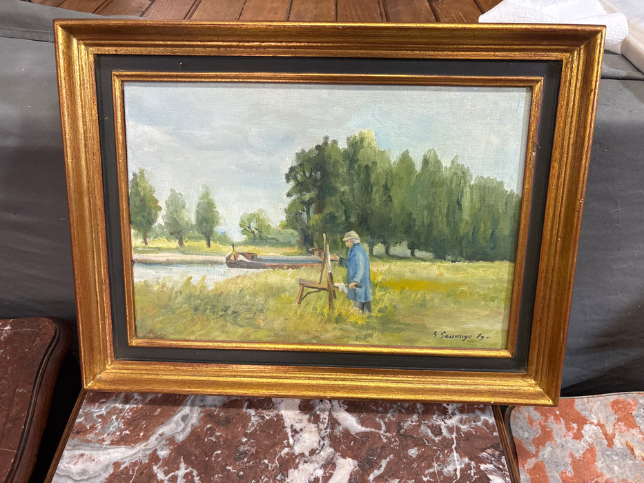BLACK AND GOLD FRAMED OIL PAINTING OF MAN PAINTING NEXT TO RIVER AND TREES - SIGNED G. SAUVAGE