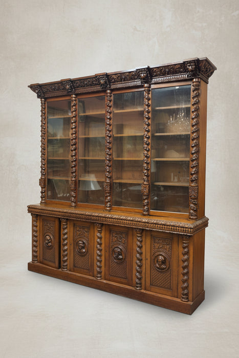 HUGE STEPBACK 4 DOOR CARVED PORTRAIT HEAD BOOKCASE WITH FOLIATE TWIST COLUMNS