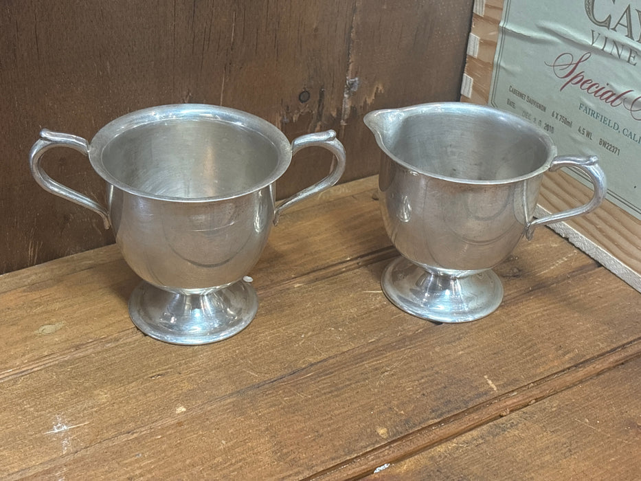 PAIR OF SILVER PLATE CREAM AND SUGAR