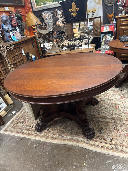 LARGE ROUND AMERICAN OAK TABLE WITH PAW FEET