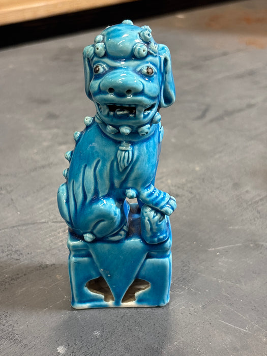 SINGLE SMALL BLUE FOO DOG RESTING HAND ON ROCK