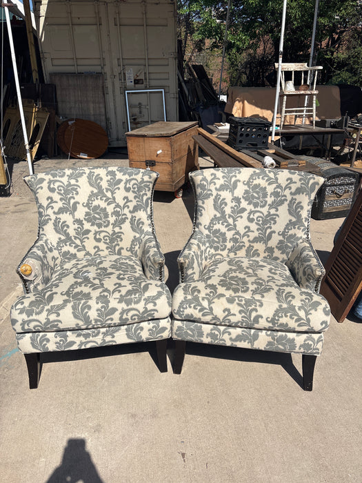PAIR OF UPHOLSTERED GRAY AND WHITE FOLIATE CHAIRS - AS FOUND