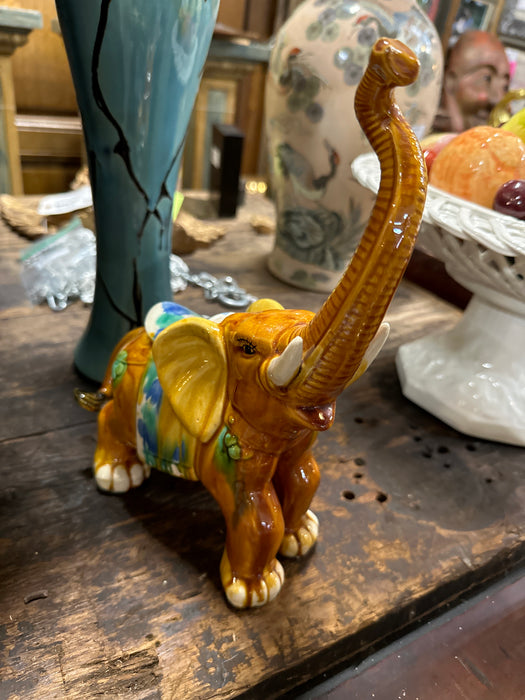 SMALL DARK GOLD AND MULTICOLORED POTTERY ELEPHANT