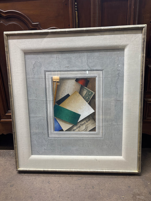 MEDIUM SILVER GILT FRAMED PRINT OF COLORFUL ASSORTMENT OF DESK PAPERS IN GRAY MATTE