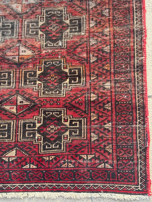SMALL RED AND BLACK HAND TIED RUG - AS FOUND
