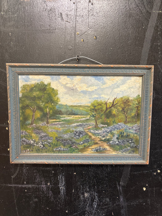 BROWN AND BLUE FRAMED OIL PAINTING OF DIRT ROAD WITH BLUE BONNETS