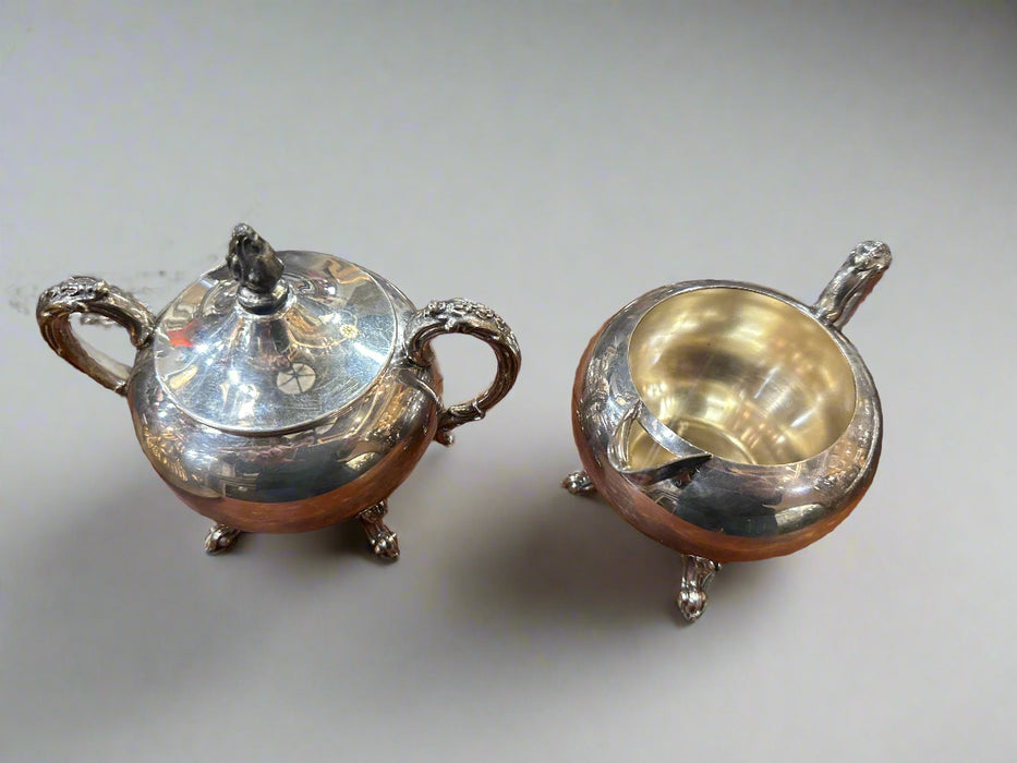 PAIR OF ORNATE CREAM AND SUGAR