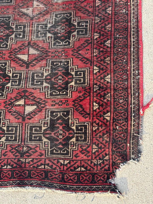SMALL RED AND BLACK HAND TIED RUG - AS FOUND