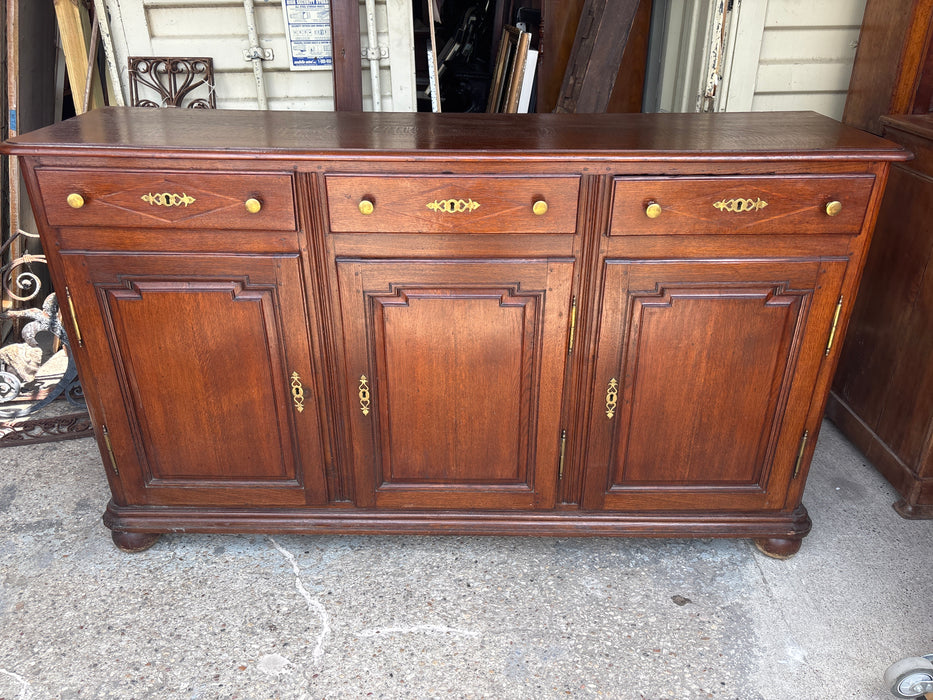 3 DOOR BRASS HANDLED PANELED OAK SIDEBOARD