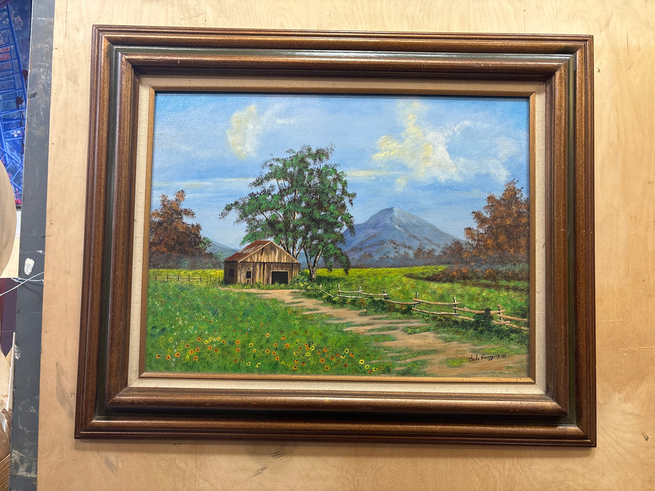 LARGE BROWN FRAMED ACRYLIC PAINTING ON BOARD OF BUILDING IN FIELD OF FLOWERS - SIGNED THEDA SCROGGINS
