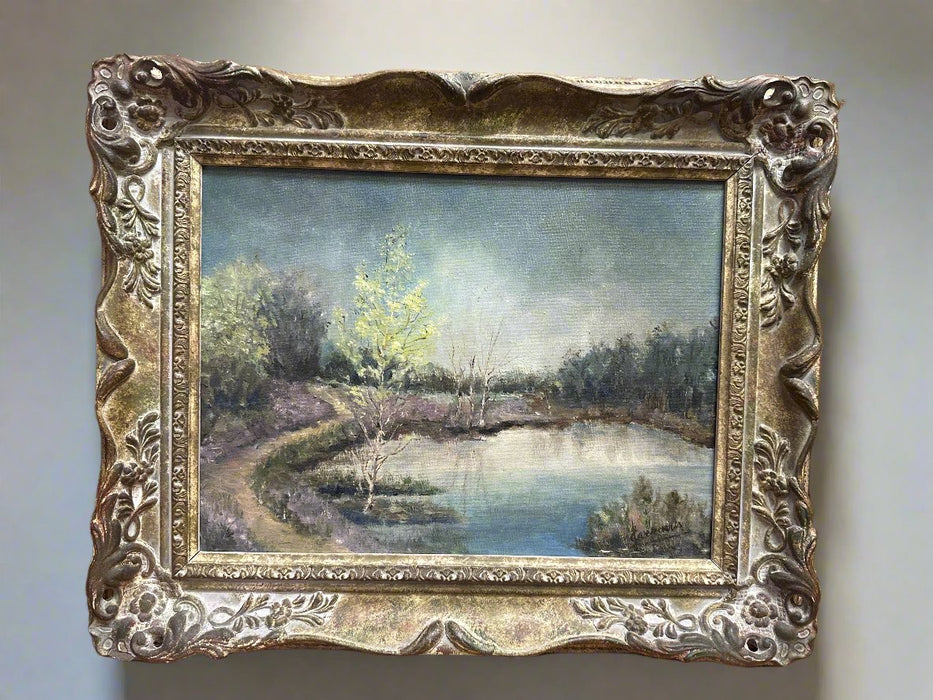 FRAMED OIL PAINTING OF POND LANDS IN LAVENDER AND GREEN HUES