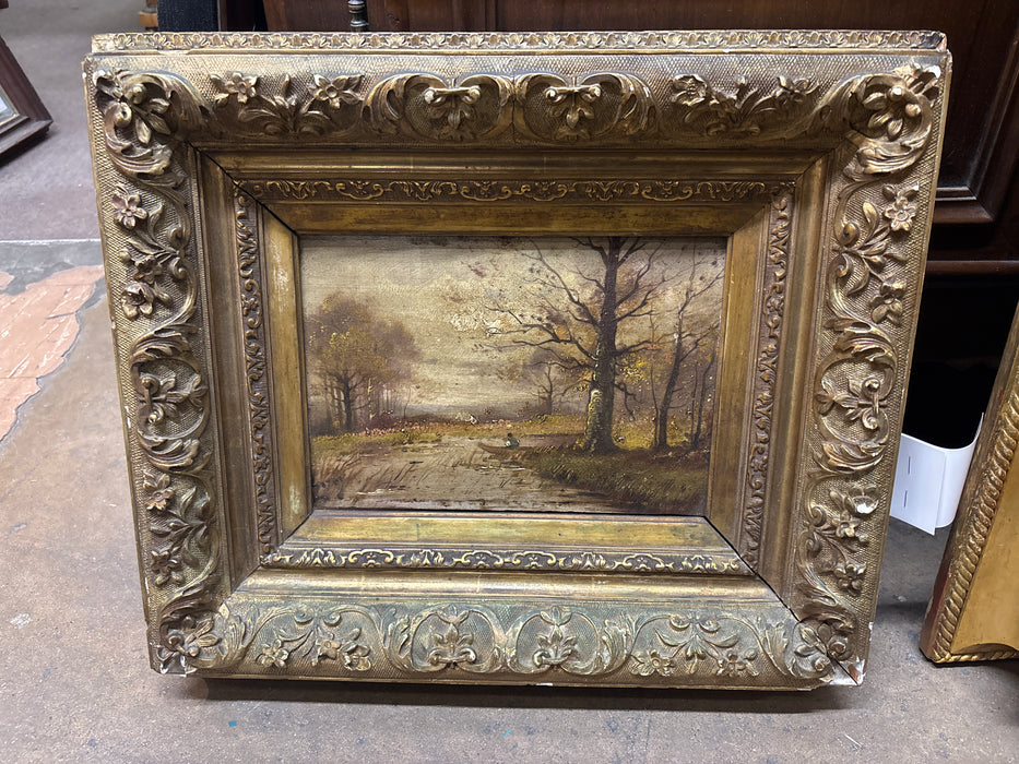 SMALL FLORAL GILT FRAMED OIL PAINTING OF FOREST RIVER AND BOY IN BOAT