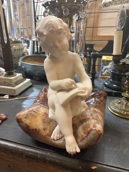 MARBLE STATUE OF BOY SITTING ON BLANKET READING