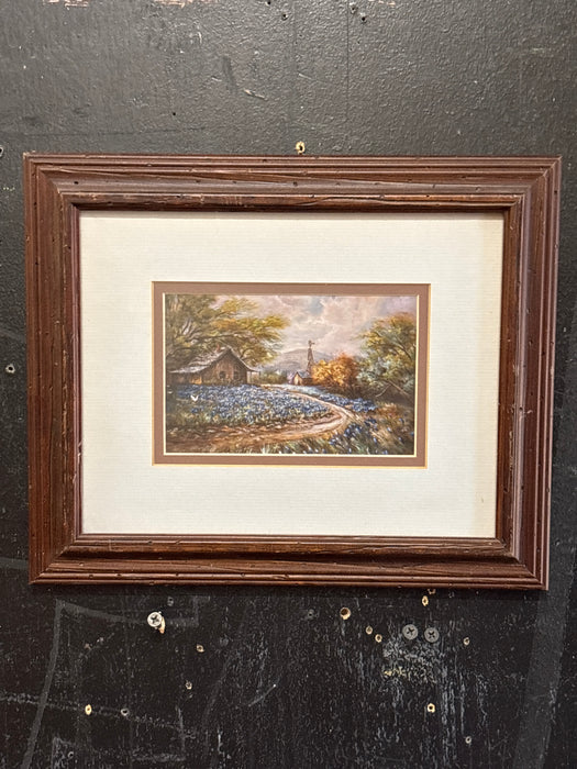 BROWN FRAMED WATERCOLOR OF HOUSE WITH BLUE BONNETS AND WHITE MATTE