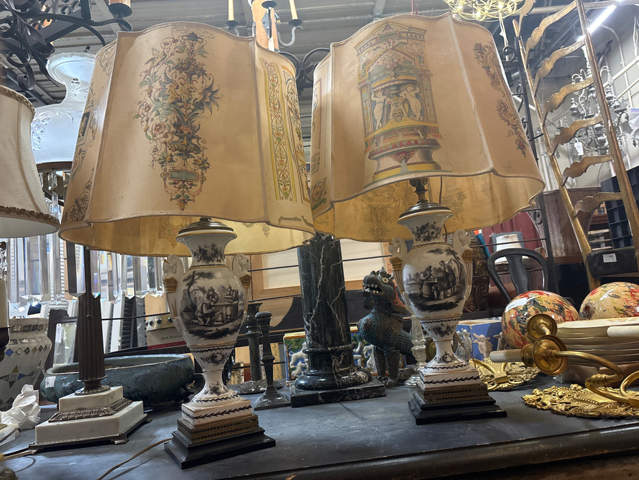 PAIR OF BLACK AND WHITE PORCELAIN URN SHAPED LAMPS WITH PEOPLE AND CLASSIC SYMBOL SHADES