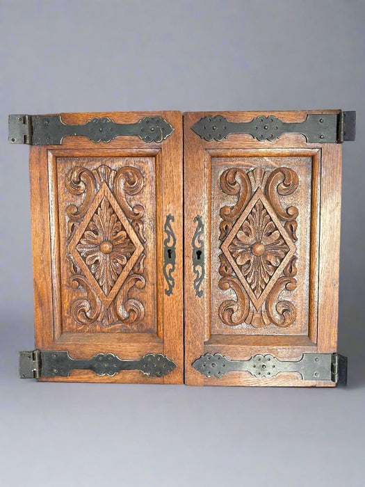 PAIR OF SMALL CARVED OAK DOORS WITH IRON STRAP HINGES