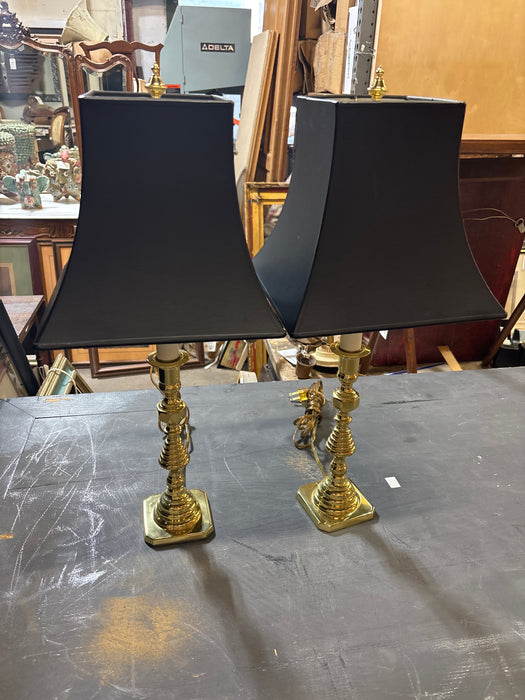 PAIR OF BRASS CANDLESTICK LAMPS WITH BLACK SHAPED SHADES